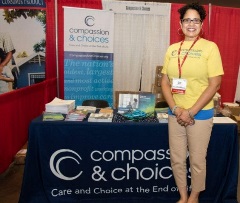 Wendy Minor stands in front of our table at an event