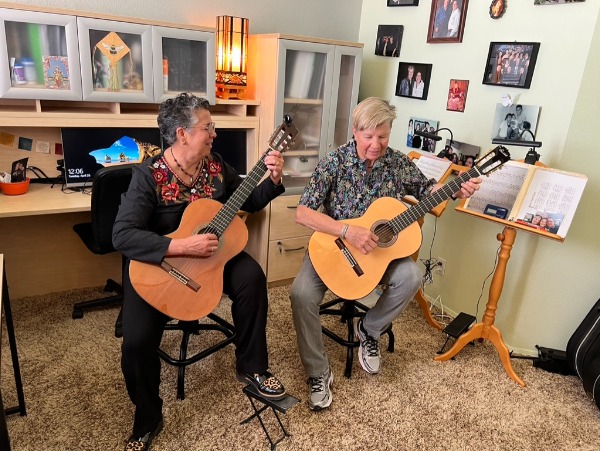 Norma Vázquez de Houdek (L) with wife Mary Houdek play guitars after the filming at their home in Albuquerque, New Mexico. 