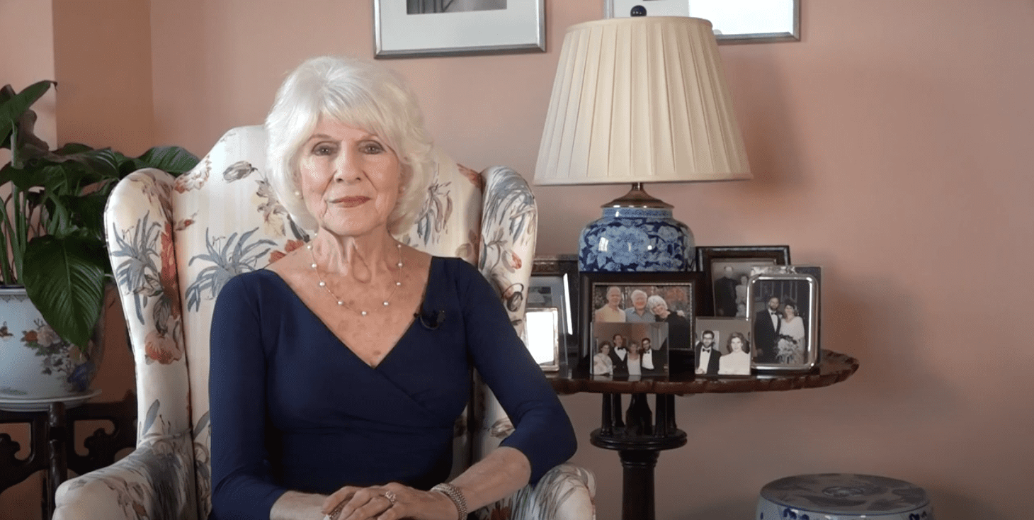 Diane Rehm seated in front of photos