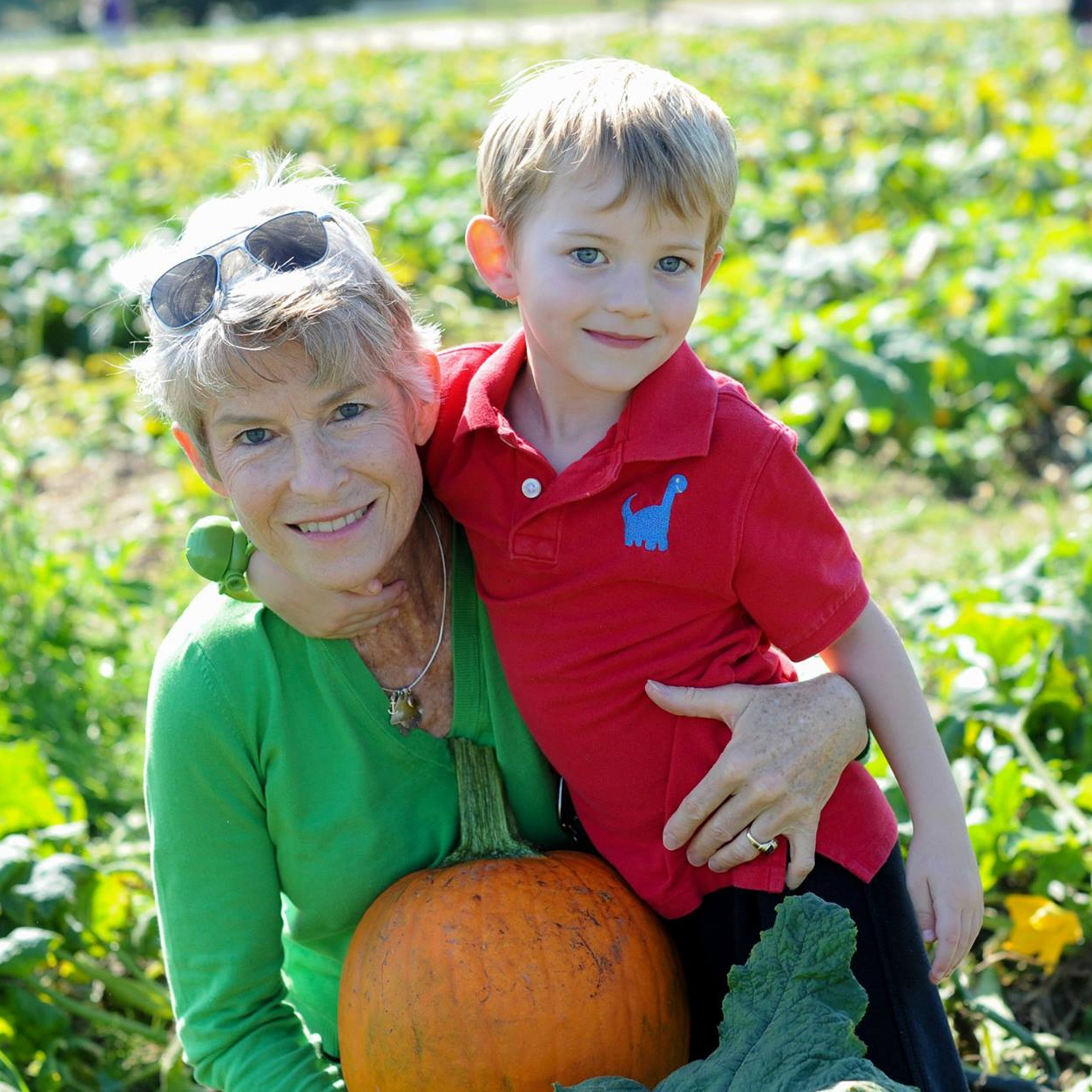 Jane Pressly and Andrew picking pumpkins