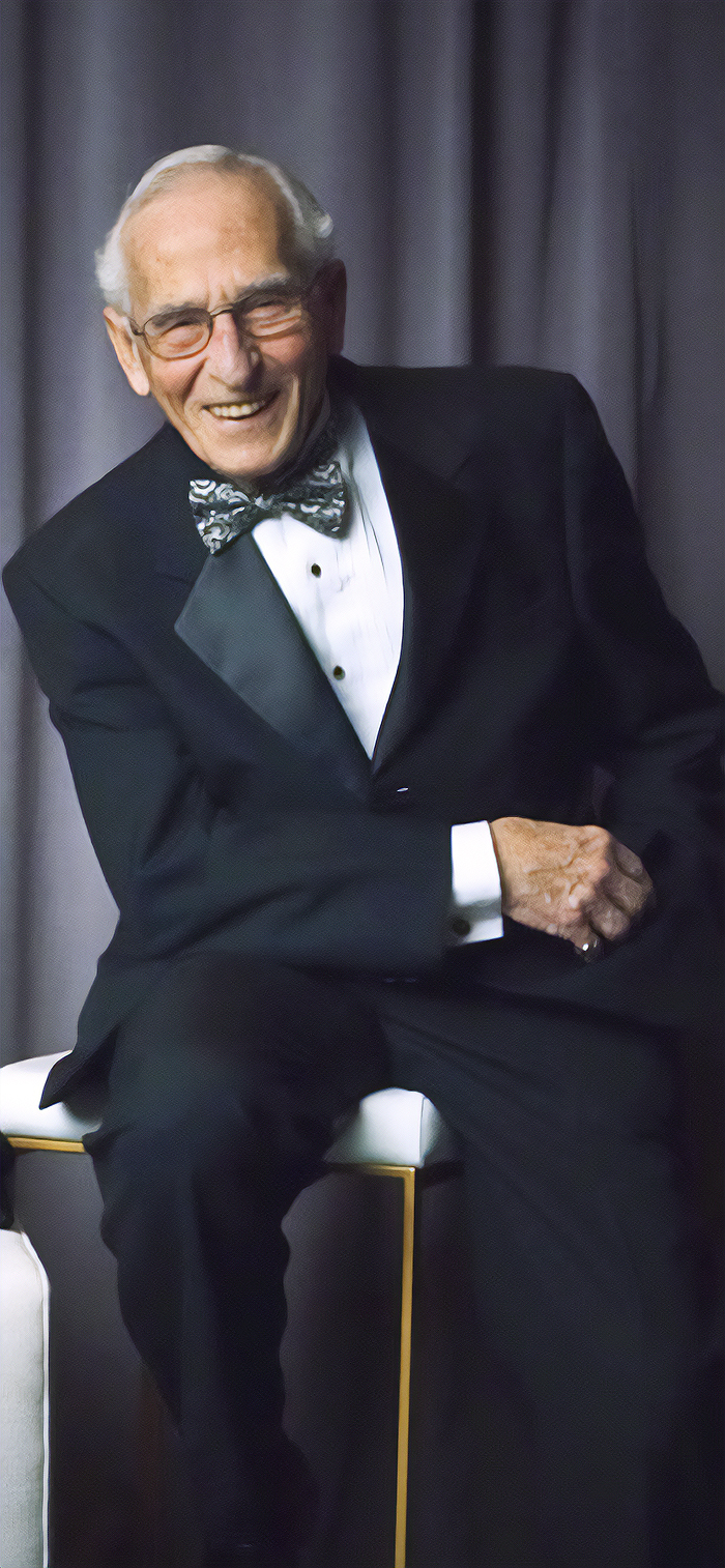 ed Rubenstein wearing a tuxedo sitting on a table
